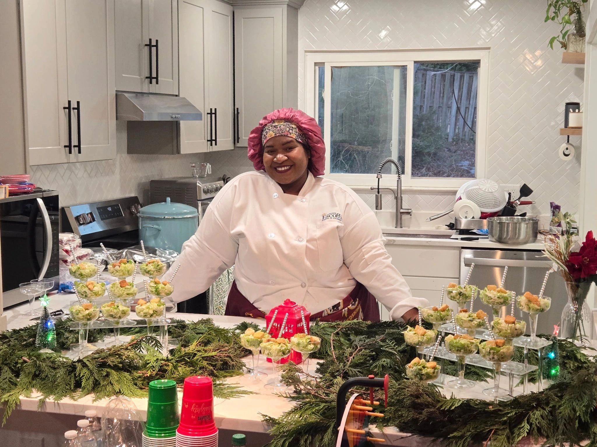 Chef Shanika in the kitchen presenting plated appetizers