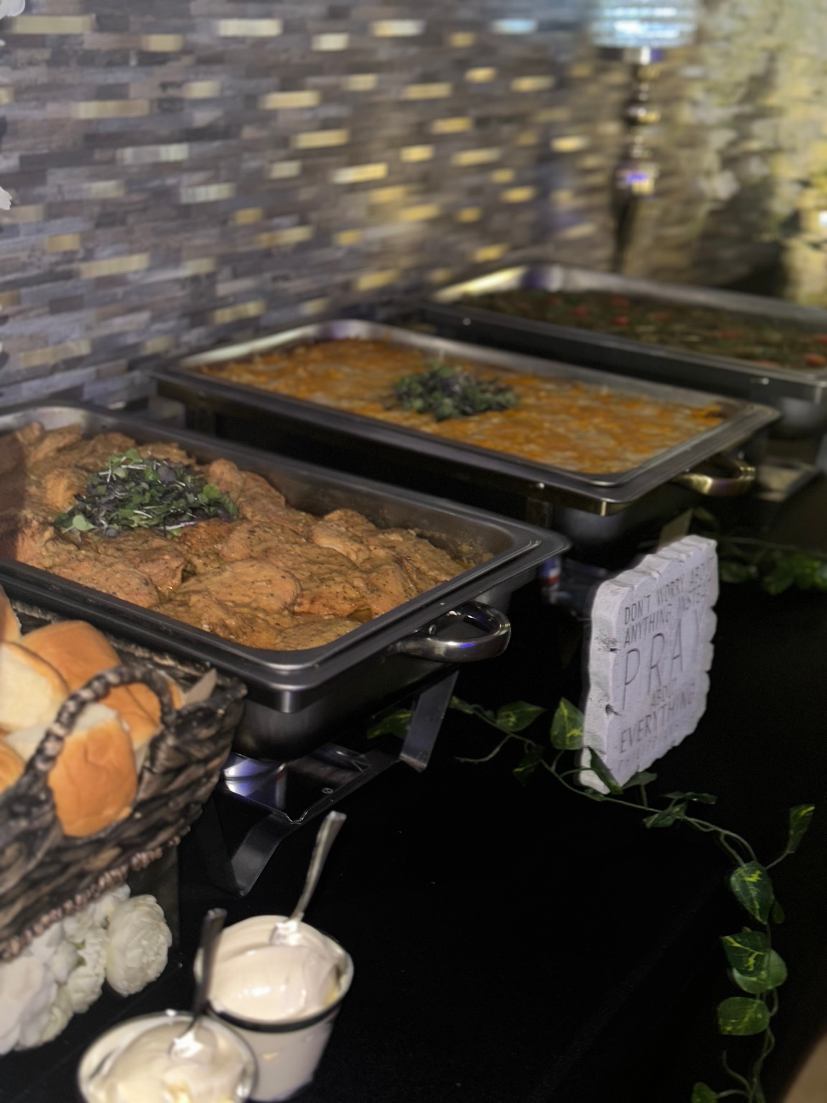 Plated dishes in black serving trays with garnish