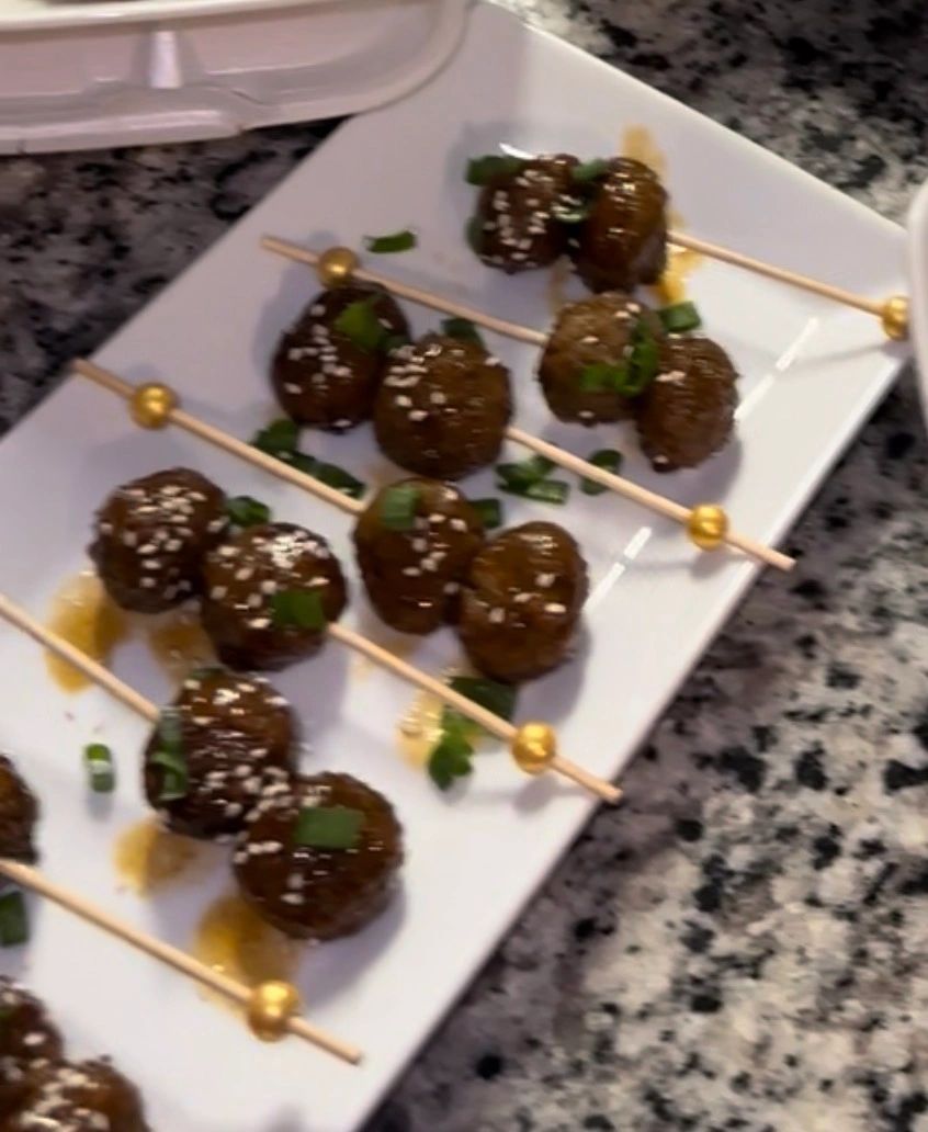 Glazed meatballs on gold skewers